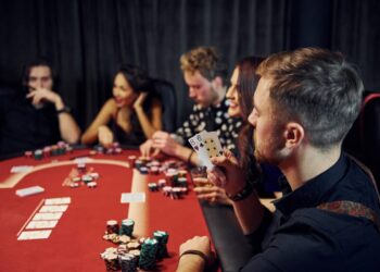 group elegant young people that playing poker casino together